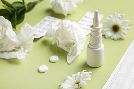 Photo for Nasal drops with pills, flowers and tissues on green background, closeup. Seasonal allergy concept - Royalty Free Image