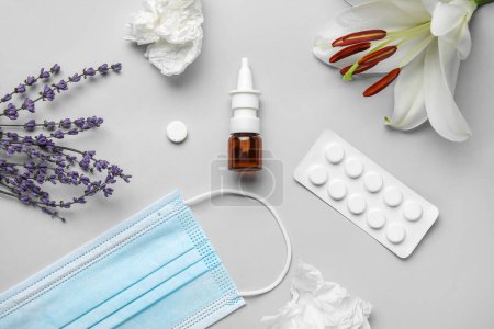 Photo for Nasal drops with pills, flowers, medical mask and tissues on grey background. Seasonal allergy concept - Royalty Free Image