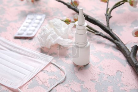 Photo for Nasal drops with pills, flowers, medical mask and tissue on grunge background, closeup. Seasonal allergy concept - Royalty Free Image