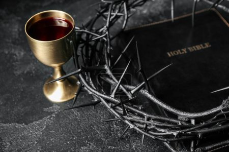 Photo for Crown of thorns with Holy Bible and cup of wine on dark background, closeup - Royalty Free Image