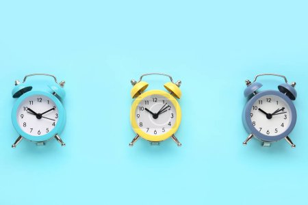 Alarm clocks on blue background