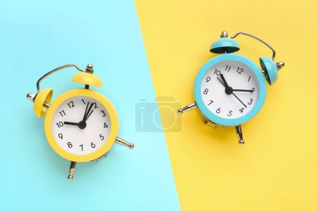 Photo for Alarm clocks on blue and yellow background - Royalty Free Image