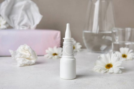 Photo for Nasal drops with flowers on white table. Seasonal allergy concept - Royalty Free Image