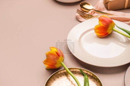 Photo for Clean plate and tulip flowers on beige background - Royalty Free Image