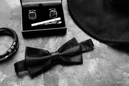 Photo for Set of male accessories with stylish bow tie on grunge background, closeup - Royalty Free Image