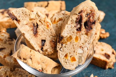 Bowl with delicious biscotti cookies on grunge background