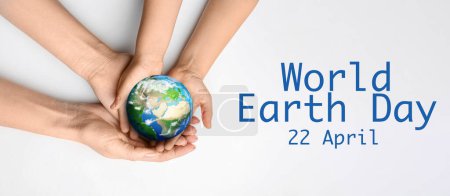 Photo for Hands of mother and child holding small planet on light background. World Earth Day - Royalty Free Image