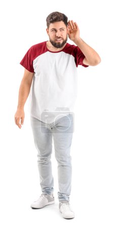 Photo for Young man trying to hear something on white background - Royalty Free Image