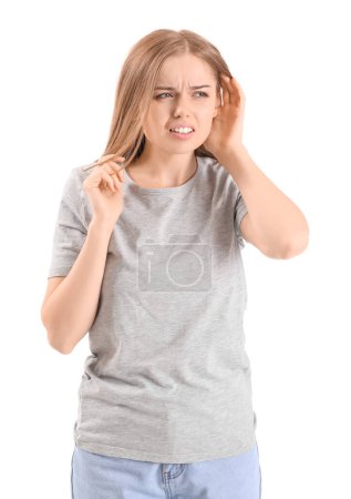 Téléchargez les photos : Irritated young woman suffering from loud noise on white background - en image libre de droit