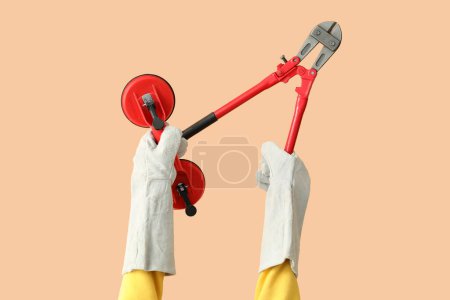 Photo for Female worker with tools on beige background - Royalty Free Image