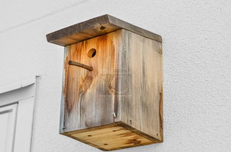 Photo for Wooden bird house on white wall outdoors - Royalty Free Image