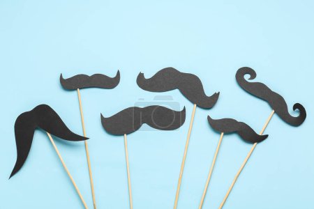 Photo for Set of different paper mustaches on sticks against color background - Royalty Free Image