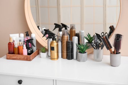 Hair sprays with accessories on table in beauty salon