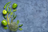 Composition with different fresh green vegetables on blue grunge background Poster #647489304