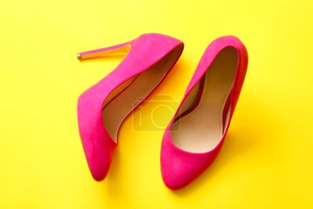Photo for Pair of stylish high heeled shoes on yellow background - Royalty Free Image
