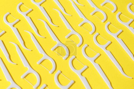 Photo for Many floss toothpicks on yellow background - Royalty Free Image