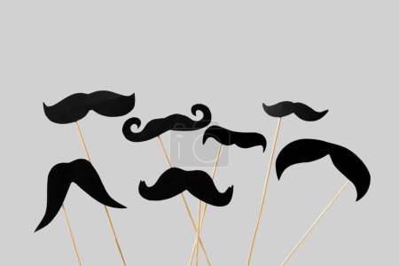 Photo for Wooden sticks with different paper mustaches on grey background - Royalty Free Image