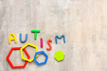 Word AUTISM with blocks on grunge background