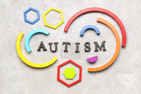 Word AUTISM with baby blocks on grunge background