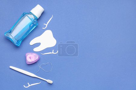 Photo for Set for oral hygiene and tooth model on blue background - Royalty Free Image