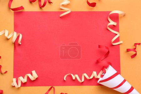 Photo for Blank card with party cone and serpentine on orange background - Royalty Free Image