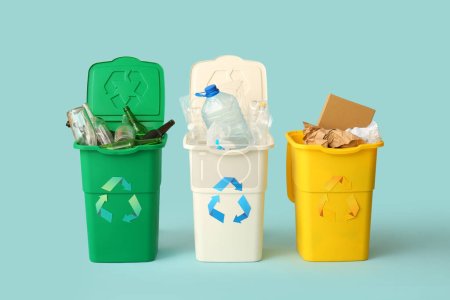 Photo for Containers with different types of garbage on light blue background. Recycling concept - Royalty Free Image