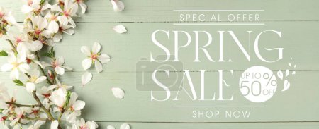 Beautiful blossoming tree branches on green wooden background. Spring sale