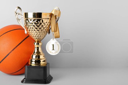 Photo for Gold cup with first place medal and ball on light background - Royalty Free Image