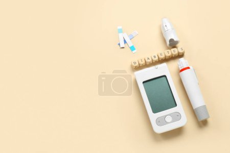 Photo for Word DIABETES with glucometer and lancet pen on beige background - Royalty Free Image