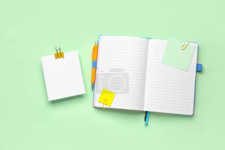 Photo for Sticky notes and notepad on green background - Royalty Free Image