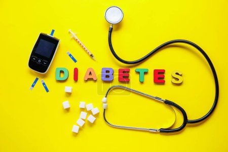 Photo for Word DIABETES with sugar, glucometer and syringe on yellow background - Royalty Free Image
