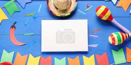 Photo for Blank paper, sombrero, maracas and Mexican decor on blue wooden background - Royalty Free Image