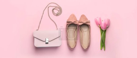 Photo for Stylish handbag with female shoes and tulip flowers on pink background - Royalty Free Image