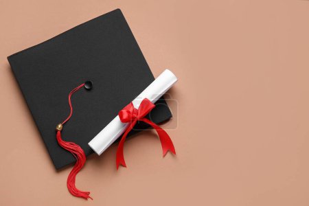Photo for Diploma with red ribbon and graduation hat on brown background - Royalty Free Image