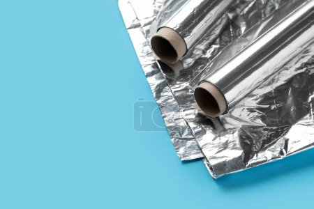 Aluminium foil rolls and sheet on color background