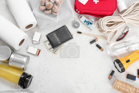 Photo for Frame made of necessities for emergency bag on white table - Royalty Free Image