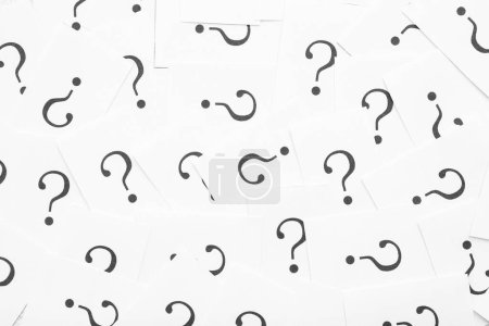 Photo for White papers with question marks as background - Royalty Free Image
