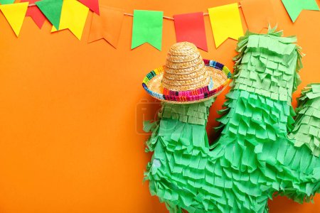Mexikanische Pinata mit Sombrero-Hut und Flaggen auf farbigem Hintergrund