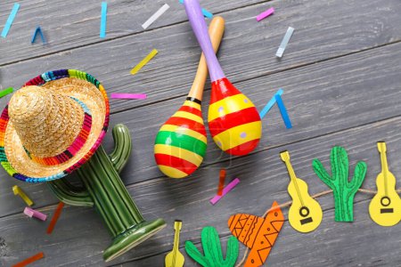 Photo for Mexican maracas with sombrero hat, cactus and garland on dark wooden background - Royalty Free Image