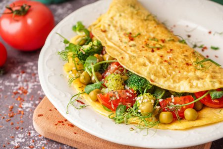 Photo for Tasty omelet with vegetables on grey grunge background - Royalty Free Image