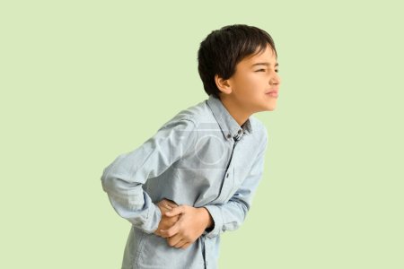 Photo for Little boy with appendicitis on green background - Royalty Free Image