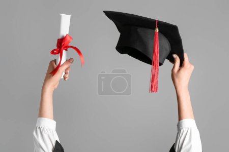 Photo for Woman with graduation hat and diploma on grey background - Royalty Free Image