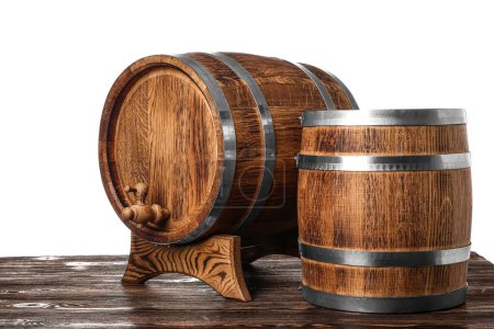 Wooden barrels on table against white background