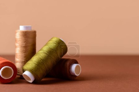 Photo for Multicolored sewing threads on color background - Royalty Free Image