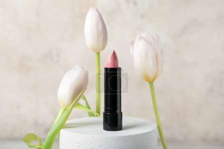 Photo for Decorative plaster podium with lipstick and tulip flowers on white grunge background - Royalty Free Image