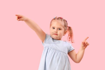Photo for Funny little girl showing loser gesture on pink background - Royalty Free Image