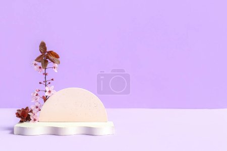 Photo for Decorative podiums and blooming branch on lilac background - Royalty Free Image