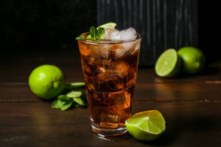 Photo for Glass of tasty Cuba Libre cocktail on table - Royalty Free Image