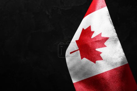 Flag of Canada on dark background, closeup
