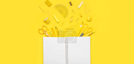 Photo for Empty notebook and set of school supplies on yellow background - Royalty Free Image